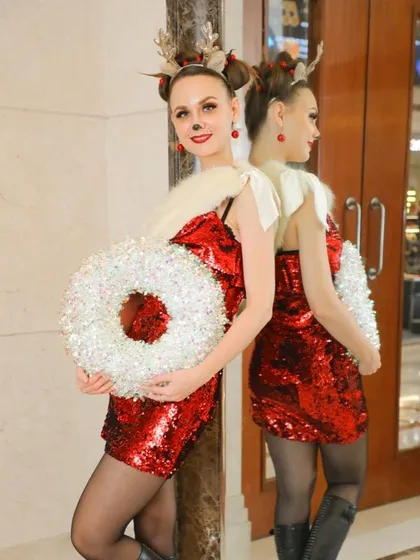 This photo uses a mirror to create an interesting composition of a performer in her festive outfit. It's a creative way to add depth to event photos.