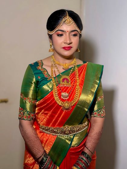 Prerna looking absolutely stunning for her Muhurtham. The makeup is traditional yet fresh, with a focus on radiant skin and classic red lips.