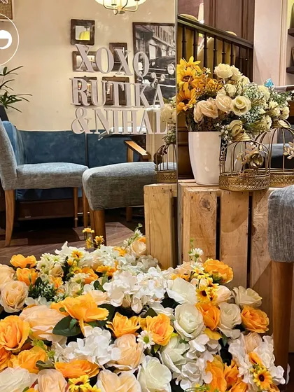 A floor-level view of a honeybee-themed baby shower, showing how floral arrangements can be used to ground a space and add a touch of luxury.