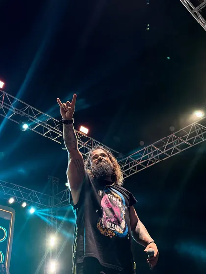 Rock on! This is the universal sign for a good time, and it's what our shows are all about. Our frontman, Keyoor, making sure everyone is part of the madness at a flea market gig in Surat.