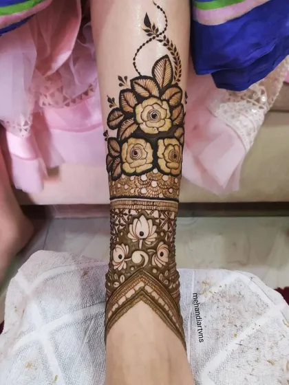 A complete leg design showing how a modern floral band can be beautifully paired with a traditional lotus pattern on the foot.