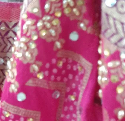 A close-up look at the beautiful mirror and sequin work on a fabric. I take pride in the quality of materials and the intricacy of the craftsmanship in my projects.