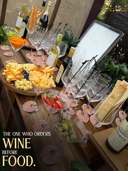 A closer look at our elegant wine and cheese station. We provide a curated selection of wines, artisanal cheeses, fresh fruits, and crackers for a sophisticated touch at any wedding or event.