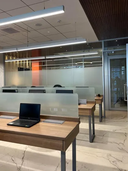 The open-plan workspace in the advocate's office is designed for focus and collaboration. Frosted glass partitions provide privacy while allowing light to flow through the space, and marble floors add a touch of luxury.