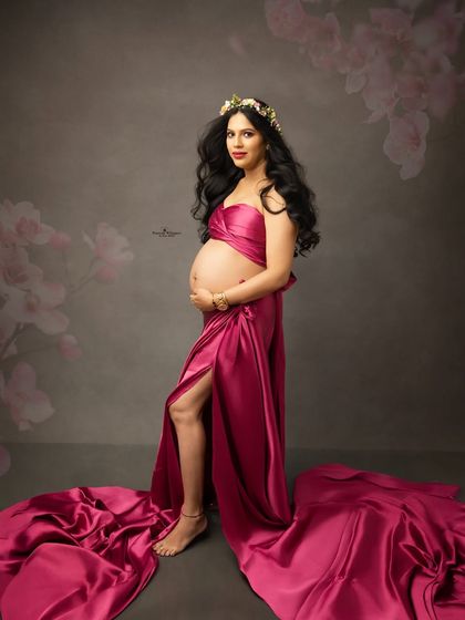 A bold and beautiful solo portrait in a striking magenta gown. The fabric wrap style and floral crown create a look that is both powerful and feminine.