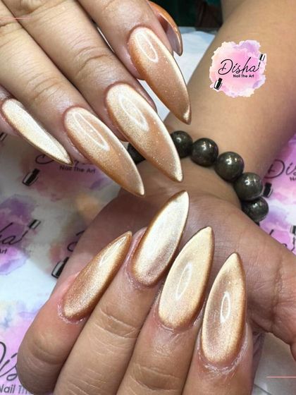 Gold isn't just a color, it's a statement. These long, stiletto-shaped cat eye nails in a brilliant gold are the definition of glamour.