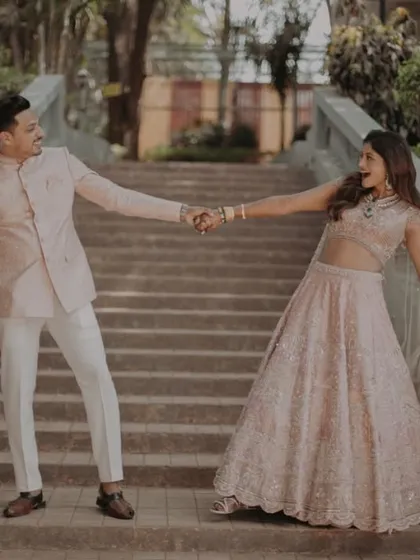 A playful, dynamic shot of the couple on the stairs, capturing movement and their joyful connection.
