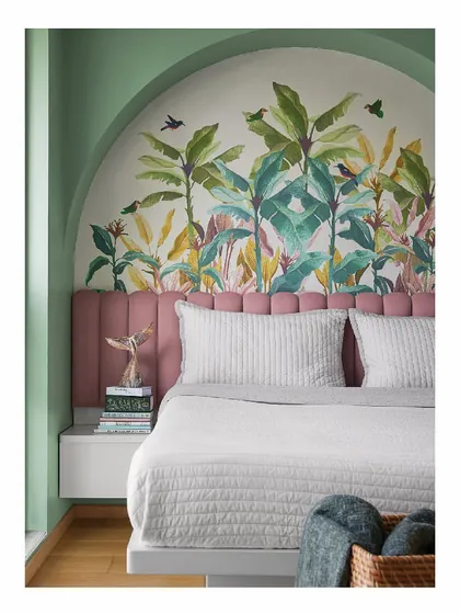 We designed this child's room to be a space for imagination to flourish. A custom tropical wallpaper and candy-floss pink headboard are set against sage green walls, while a writable wardrobe surface gives creativity free rein beyond just paper.