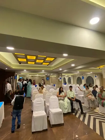 A wide view of a party hall set up for a Boss Baby themed event, showing how we arrange seating and decor to create a cohesive and welcoming space for guests.