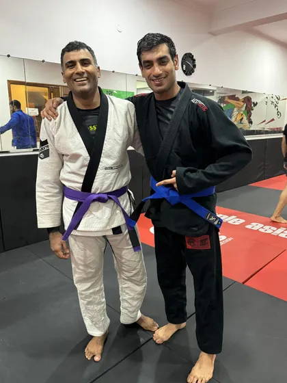 Another member of our team congratulating our newly promoted Purple Belt. Promotions are a team celebration, reflecting the effort of every training partner.