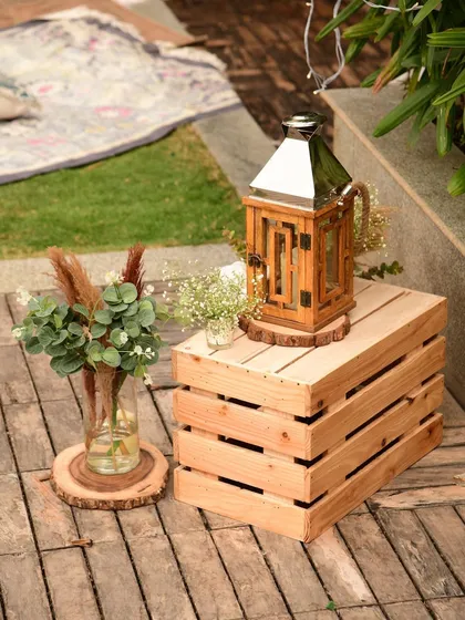 We used wooden crates and lanterns as accent pieces around the main seating area to enhance the natural, earthy, and rustic aesthetic.