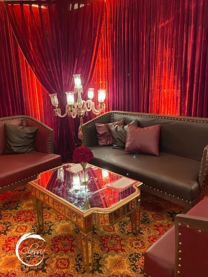 A cozy and intimate seating nook within the larger event. I paired classic leather sofas with a mirrored table and a silver candelabra to create a quiet, sophisticated corner.