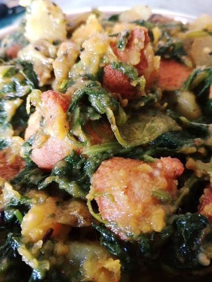 Palong Shakeyr Ghonto, a simple and rustic spinach dish cooked with seasonal vegetables and fried lentil dumplings (bori) for added texture. It's the perfect first course with hot rice.