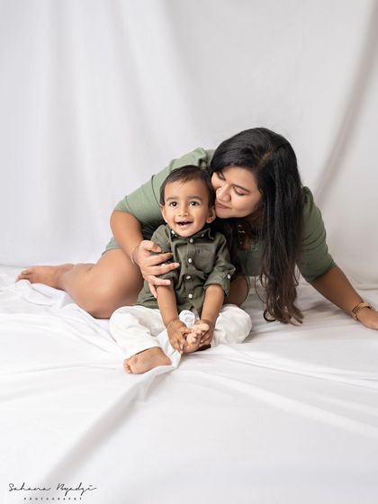 A mother's gentle embrace. This simple and classic portrait in matching outfits is full of love and connection.