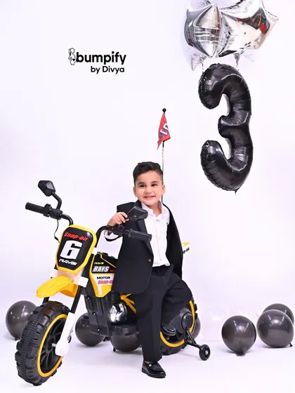 A big smile from the birthday boy. He's clearly loving the cool props and the fun atmosphere of his third birthday studio session.