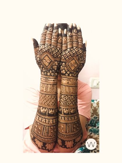 A full view of an engagement henna design, showcasing the symmetry and detail that extends from the fingertips to the elbows.