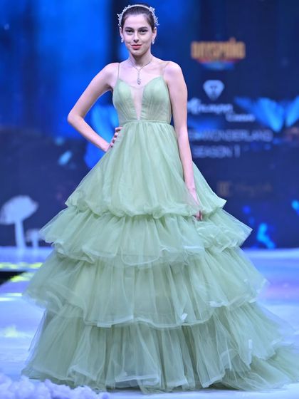 A fresh take on evening wear from my GULFAM collection. This sage green gown features a plunging neckline and a dramatic, multi-tiered tulle skirt that creates beautiful volume and movement.