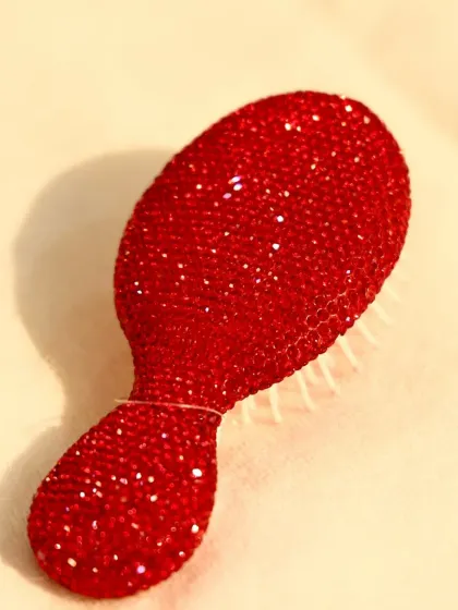 A gift that's both practical and glamorous. This sparkling red crystal-studded hairbrush is a unique and thoughtful present for the person who has everything.