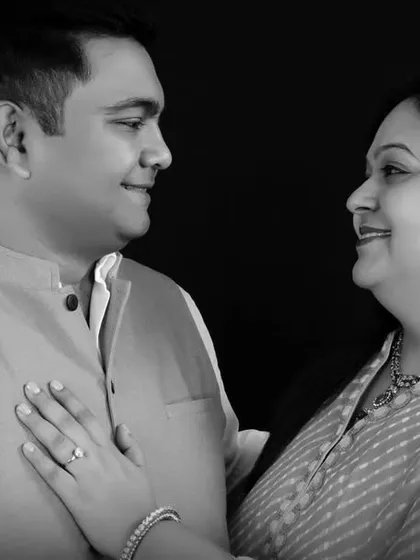 A gentle, candid moment between a couple, captured in black and white. The simple studio setting removes distractions and puts the focus entirely on your connection.