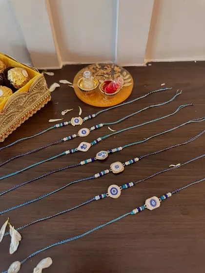 A selection of my popular evil eye rakhis. These modern, stylish designs are crafted with blue and white beads, offering a trendy way to wish your brother protection and good fortune.
