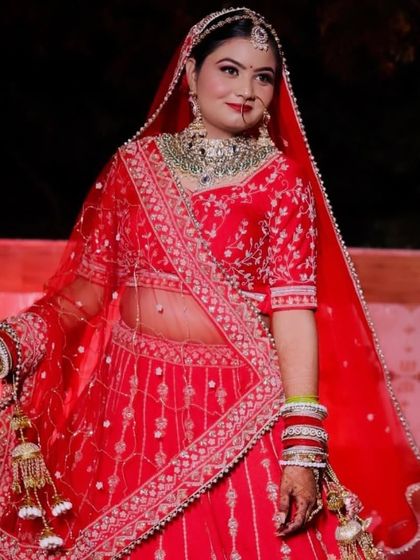 A full-length shot of Himanshi. Her red lehenga is so bright and beautiful, and she carries it with such grace.