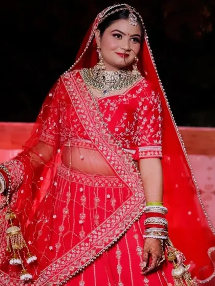 A full-length shot of Himanshi. Her red lehenga is so bright and beautiful, and she carries it with such grace.