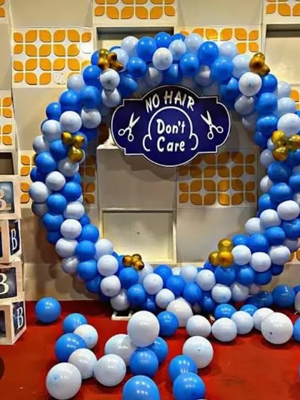 A fun and quirky "No Hair Don't Care" theme for a Mundan ceremony. The blue and white balloon ring and "BABY" blocks create a playful atmosphere for this traditional event.