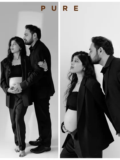 A powerful and stylish black and white portrait. The matching blazers create a chic, modern look while the gentle kiss adds a touch of softness.