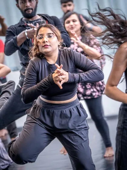 A student completely in the zone, focusing on the intricate hand movements of the choreography.