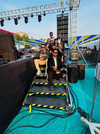 The full band and crew taking a moment behind the massive stage setup at the TCS World 10K. It takes a team to put on a great show.