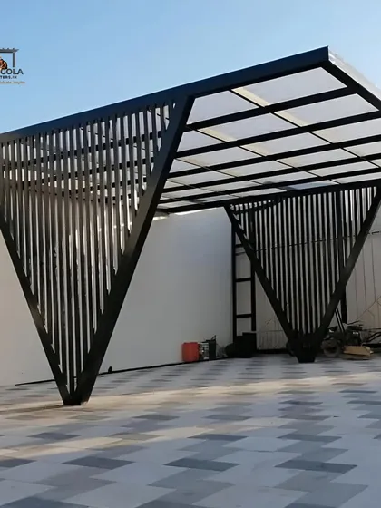 A modern car parking shelter with a unique, angular design. The structure uses vertical slats for the supports and a translucent polycarbonate roof, providing protection from the elements while maintaining a stylish, sculptural look.