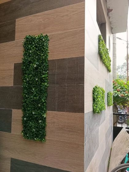 A view of the geometric green panels from the side, showing how they add dimension and visual interest to the corner of a building.