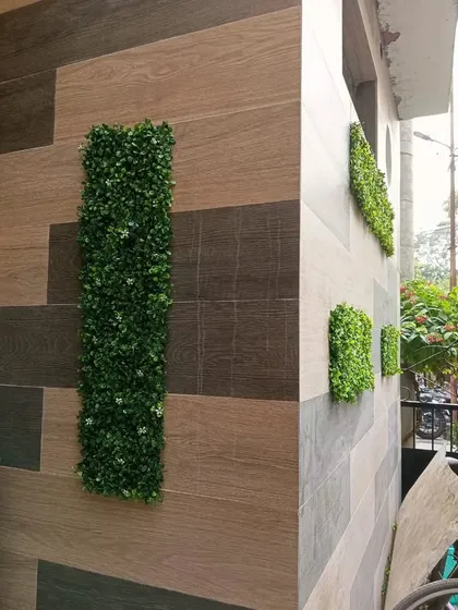 A view of the geometric green panels from the side, showing how they add dimension and visual interest to the corner of a building.