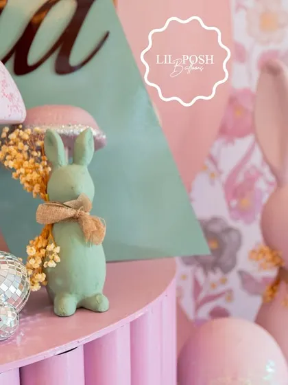 A close-up of the whimsical props, including pastel bunnies and glittery mushrooms, that brought the "Onderland" theme to life.
