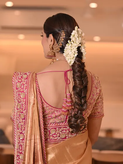 I have a special love for creating traditional hairstyles, like this intricate South Indian bridal braid, beautifully woven with fresh jasmine flowers for a fragrant and authentic touch.
