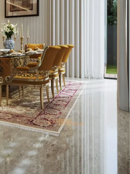 The reflective quality of the polished marble floor enhances the sense of luxury and space in this dining room. The natural light from the large window complements the warm tones of the decor.
