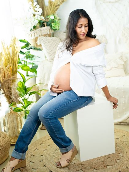Another take on the casual "white shirt and jeans" look. This portrait captures a confident and relaxed mom-to-be in our bright and airy studio.