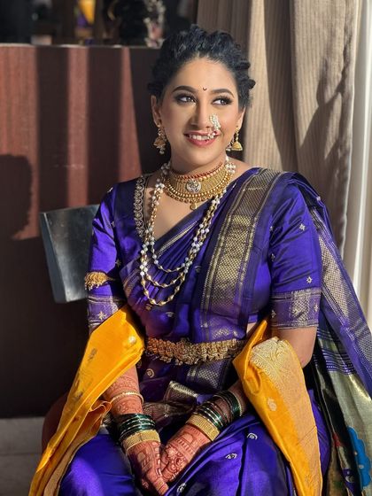 A stunning Maharashtrian bride. I created a traditional braided hairstyle that beautifully complements her purple nauvari saree and classic jewelry.