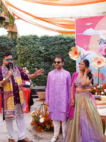 The couple on stage during their Haldi ceremony, with a quirky and colorful pop art backdrop adding a modern twist.