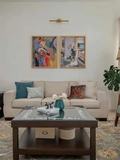 A formal living room setting in 'House of Kismish', designed for conversation. The space is arranged with comfortable sofas and armchairs, creating a welcoming atmosphere.