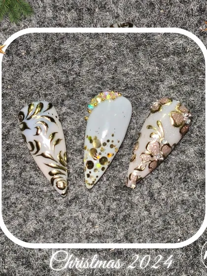 Ornate and glamorous nail art with gold foil and glitter, created by our students for a festive look.