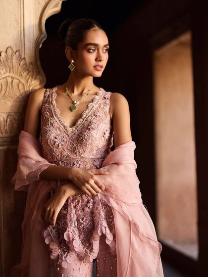 A close-up on the intricate embroidery and delicate organza dupatta. I paired this pink ensemble with a simple emerald necklace to add a pop of contrasting color, drawing attention to the neckline.