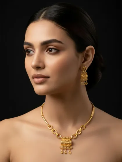 A close-up of the gold necklace set on a model, emphasizing its luxurious and classy feel. The warm glow of the gold complements the skin, showcasing how our jewellery is designed to enhance natural beauty.