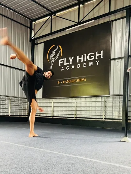 A student holds a perfect side kick, showcasing incredible flexibility and balance. This is a fundamental skill in many martial arts disciplines.