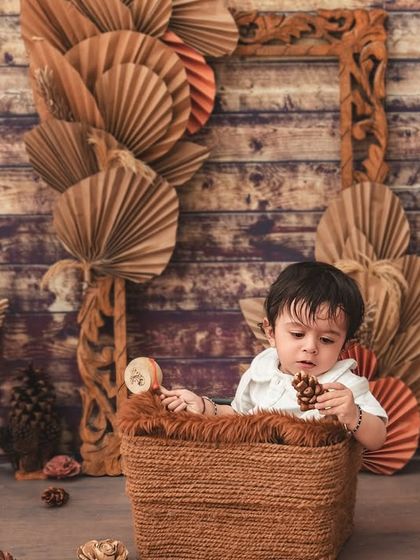 This little boy is exploring the props in our rustic, boho-themed setup, a perfect way to capture the sitter milestone.