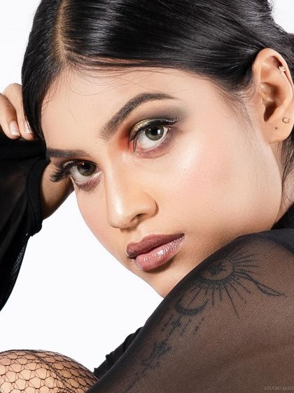 A close-up beauty shot from the "spiderwoman" series, showing the model's tattoo and makeup.