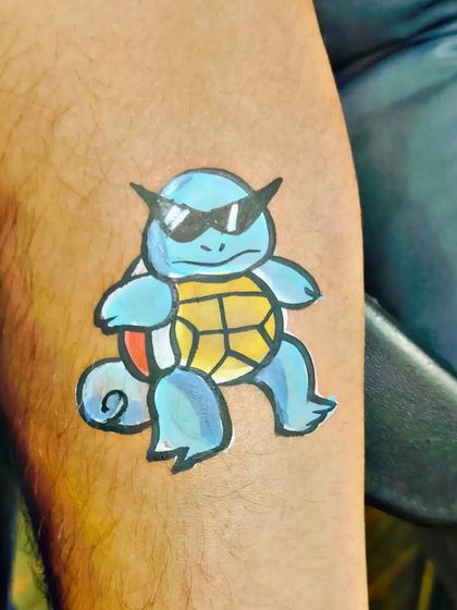 A cool temporary tattoo of the Pokemon Squirtle wearing sunglasses.