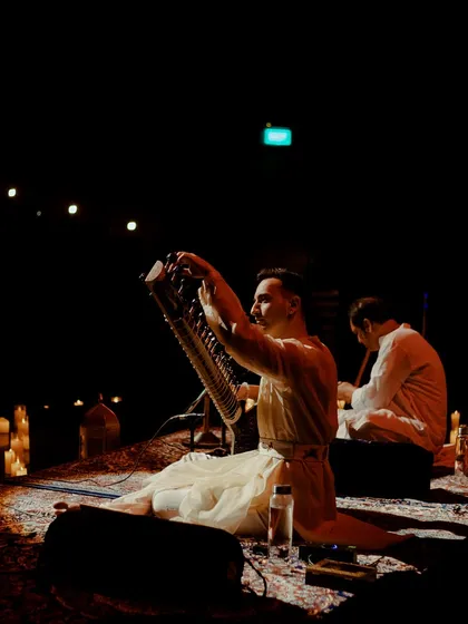 Here I am holding a swar-mandal, or autoharp, which I sometimes use to create a gentle, ambient drone to accompany meditation before the sitar performance begins.
