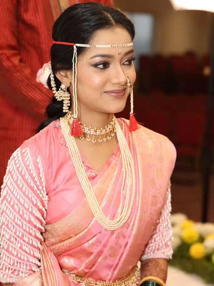A close-up of the Maharashtrian bride, showing her traditional jewelry and the subtle mehandi on her hands.