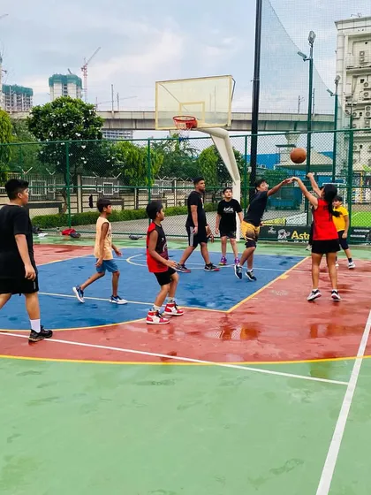 A player takes a shot on the wet court.